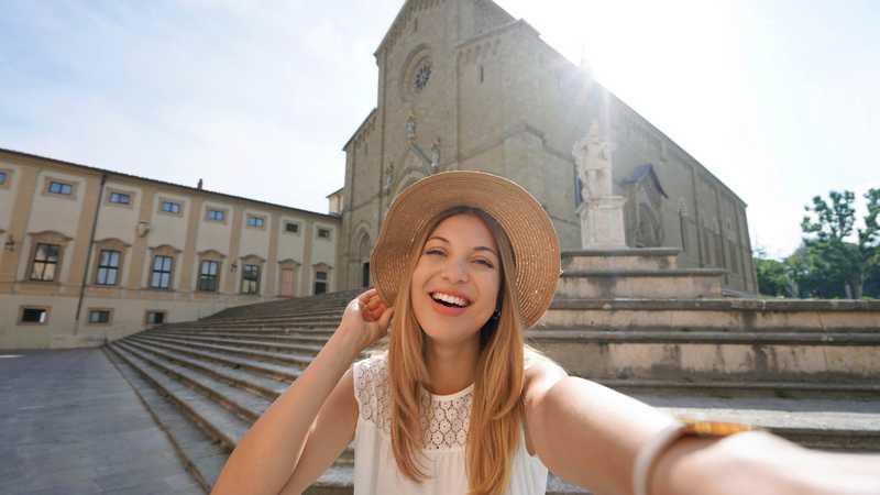 Self portrait of traveler girl in Piazza Duomo, Arezzo, Tuscany,